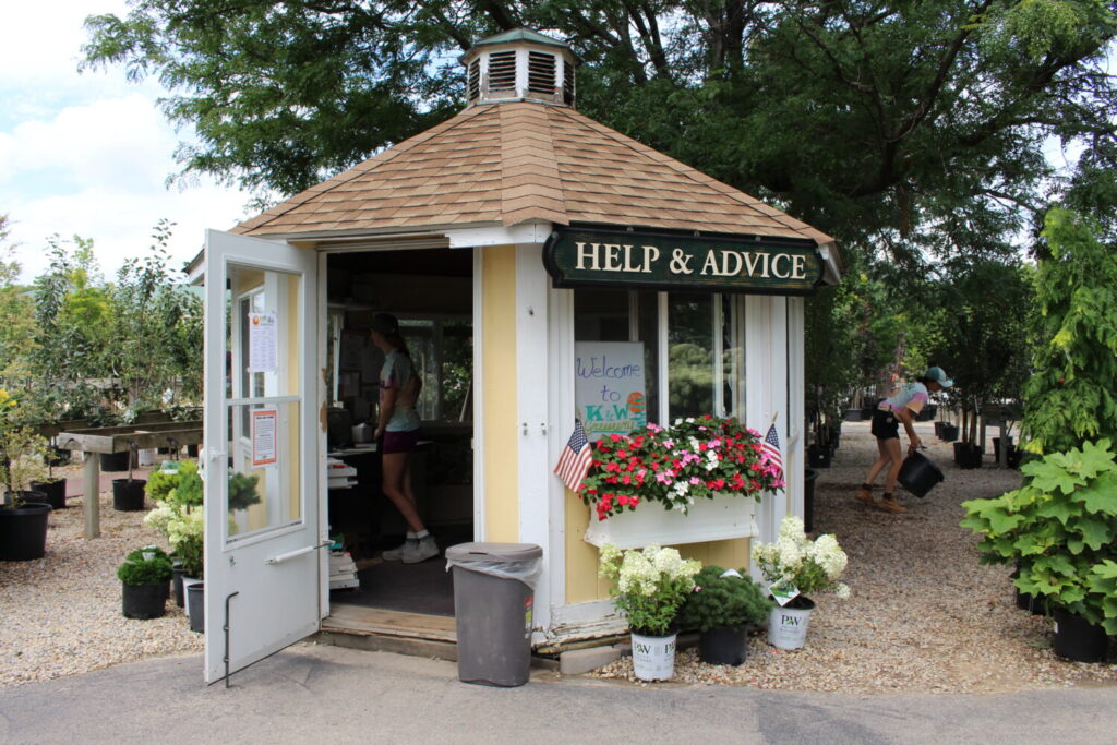 A cute help shed in the yard provides an easy-to-spot place to get plant help.