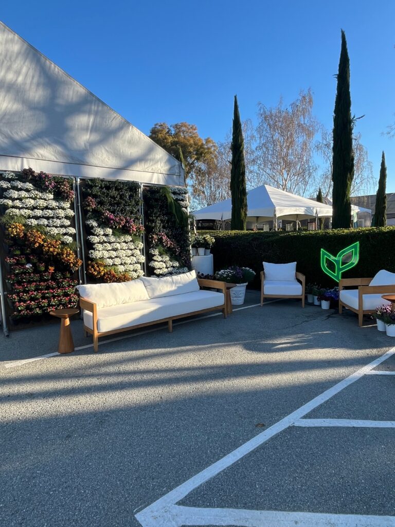 Think Plants set up a comfy lounge outside of the greenhouse, complete with patio seating and a living wall.